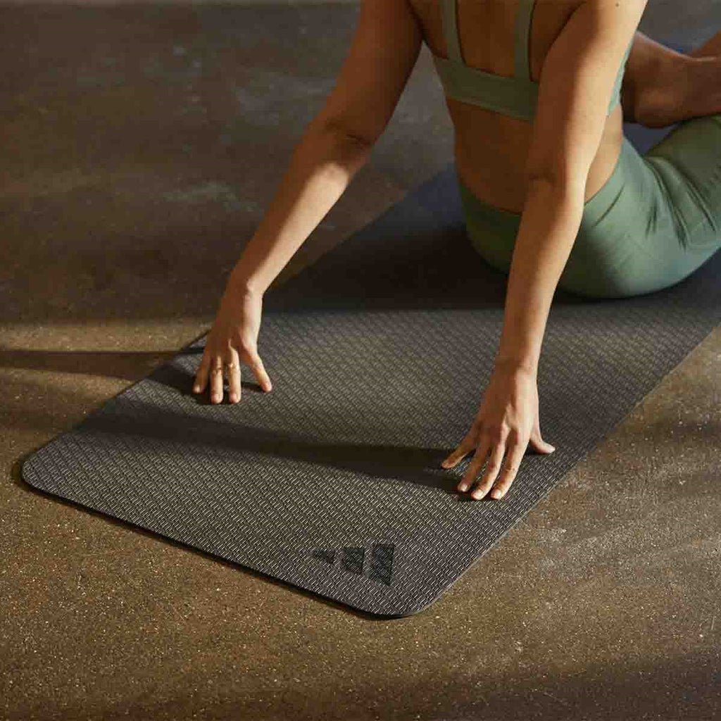 a woman stretching on a yoga mat